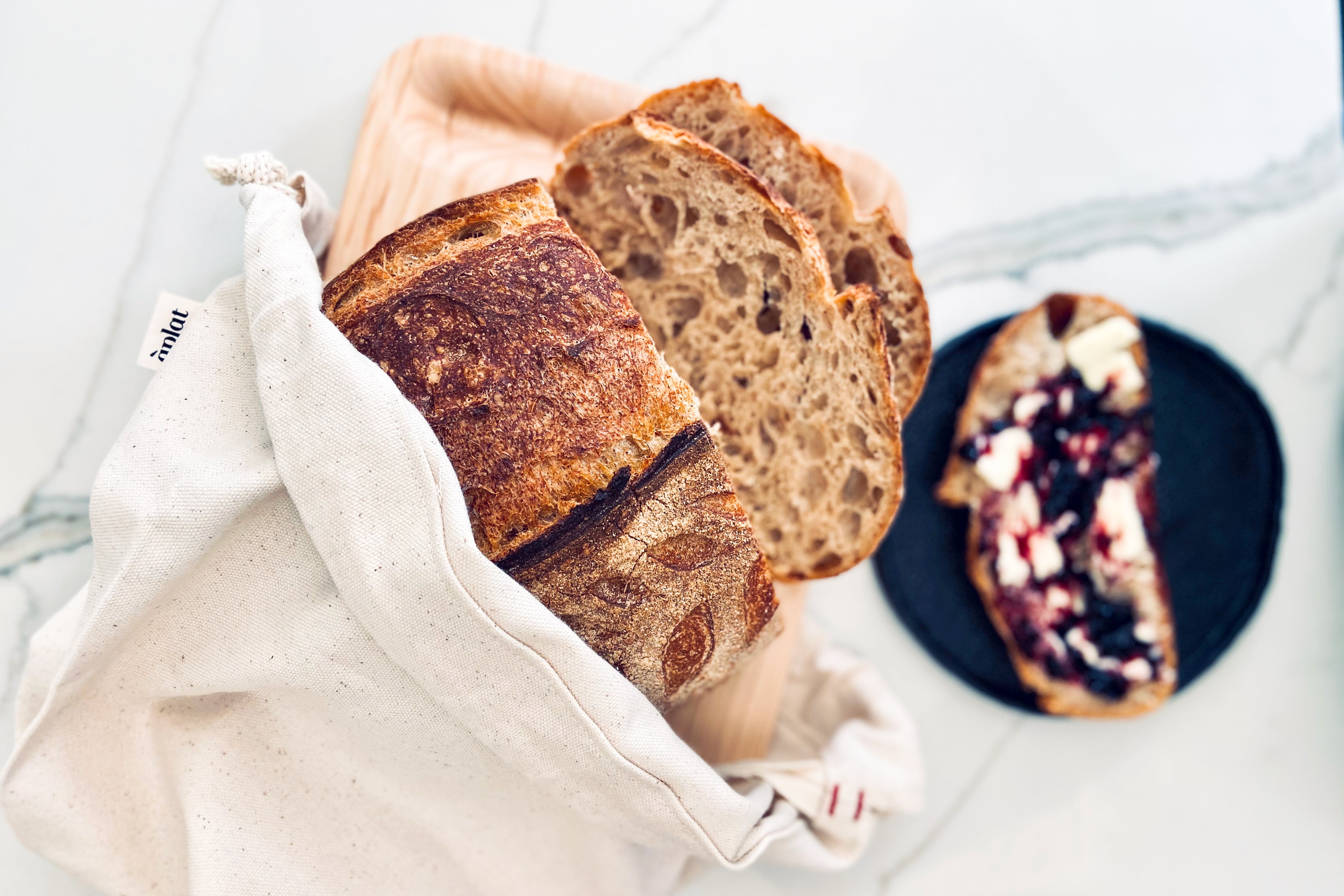 Loaves Of Bread Wrapped By A Towel by Stocksy Contributor Laura
